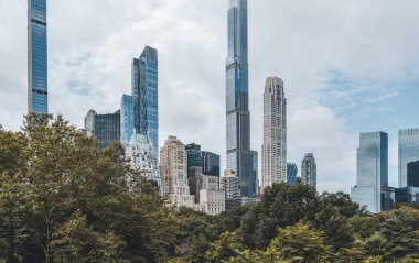New York skyscrapers and green trees at central park, cityscape in daylight. Megapolis and business corporation, financial trade center