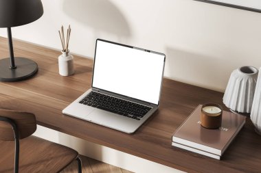 Home office interior with laptop copy space display on wooden table. Books and tools with candle, top view. Mockup blank screen, 3D rendering