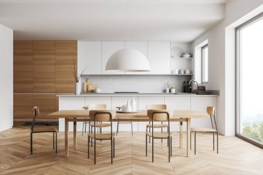 White kitchen interior with chairs and eating table, hardwood floor. Cooking room with countertop and kitchenware, panoramic window on countryside. 3D rendering