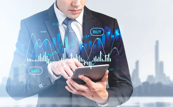 Businessman finger touch tablet in hands, stock market diagrams, business skyscrapers on background. Hud hologram with lines and candlesticks. Concept of forex