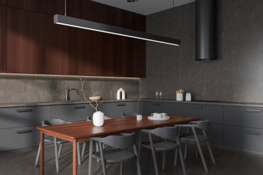 Dark kitchen interior with chairs and dining table, side view grey concrete floor. Cooking corner with shelves, hood and sink with kitchenware. 3D rendering