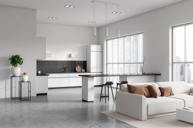 White studio interior with relaxing corner with sofa, cooking zone with bar island, grey concrete floor. Panoramic window on Singapore skyscrapers. 3D rendering