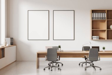 Front view on bright office room interior with two empty white posters, computers, desks, armchairs, shelves, concrete floor. Concept of company, firm, meeting space. 3d rendering