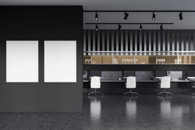 Koyu renk iç mekan, gri beton zemindeki koltuklar ve bilgisayar ile birlikte çalışıyor. Rafı ve dekorasyonu olan bir ofis. İki maket poster. 3B görüntüleme
