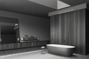 Dark bathroom interior with sink and bathtub, side view marble deck and black dresser with accessories, grey concrete floor. Copy space wooden wall. 3D rendering