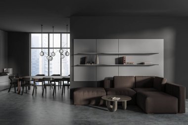 Front view on dark studio room interior with sofa, armchairs, dining table, grey wall, coffee table, partition, panoramic window with city view, concrete floor. Minimalist design. 3d rendering