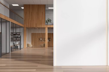 Front view on bright office room interior with empty white wall, computers, desks, armchairs, shelves with folders, oak wooden floor, window. Concept of company, firm, meeting space. 3d rendering