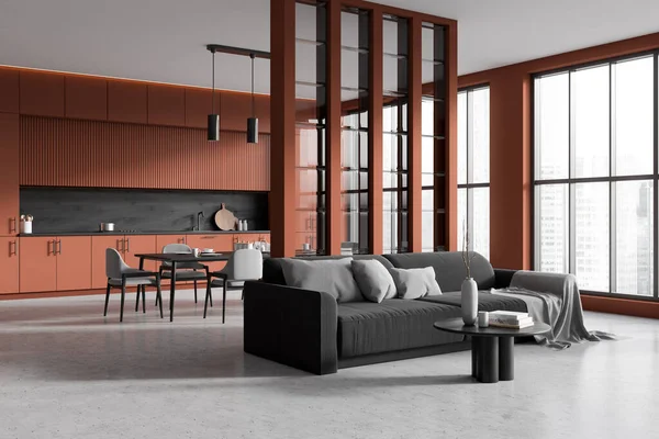 Corner view on dark studio room interior with dining table, cupboard, ocher wall, concrete floor, coffee table, panoramic window, sofa, cooking inventory. Concept of minimalist design. 3d rendering