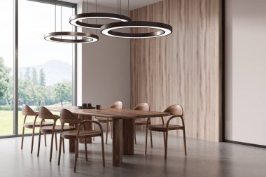 Wooden dining interior with table and chairs, side view, grey concrete floor. Panoramic window on countryside. Minimalist eating space with lamps. 3D rendering