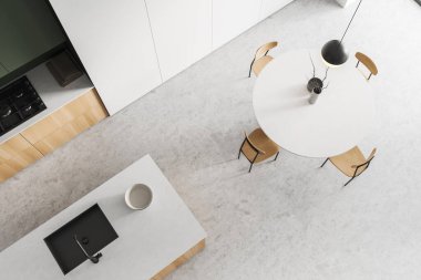 Top view of white kitchen interior and bar island with sink, dining table and chairs. Deck with appliances, shelves on light concrete floor. 3D rendering