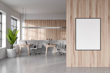 Light office interior with armchairs and laptop on table in row, grey concrete floor. Modern workspace, panoramic window on city view. Mockup canvas poster. 3D rendering