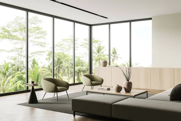 Modern living room interior with sofa and armchairs, side view, coffee table and drawer with decoration, carpet on hardwood floor. Panoramic window on tropics. 3D rendering