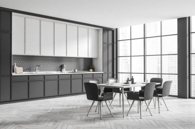 Dark kitchen interior with chairs and dining table, side view, light grey hardwood floor. Kitchenware and dishes on deck. Panoramic window on city view. 3D rendering