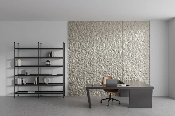 White workplace interior with laptop on desk, armchair on grey concrete floor. Minimalist shelf with art decoration. Copy space wall. 3D rendering