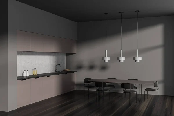 Dark kitchen interior with chairs and dinner table, side view hardwood floor. Stylish cooking corner with shelves, lamp and sink with kitchenware. 3D rendering