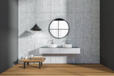 Dark bathroom interior with double sink and round mirror, reflection in window on city view. Table with bathing accessories on hardwood floor. 3D rendering