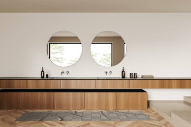 Beige bathroom interior with double sink and round mirror, foot towel on hardwood floor. Washing room with accessories in hotel apartment. 3D rendering