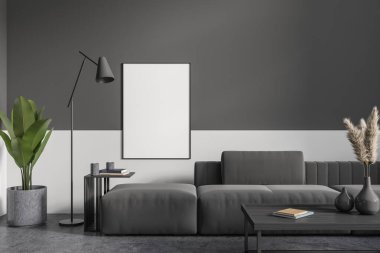 Dark living room interior with couch on grey concrete floor. Coffee table with decoration and plant, relax area in apartment. Mock up canvas on wall. 3D rendering