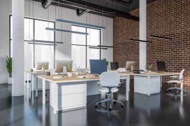 Business interior with armchairs and pc computer on table in row, side view, dark concrete floor. Open space brick loft with panoramic window on Singapore city view. 3D rendering