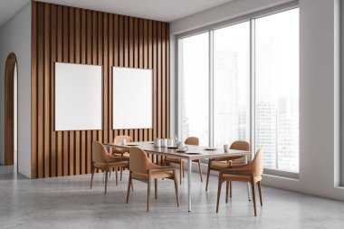 Modern dining room interior with dinner table and chair, side view grey concrete floor. Panoramic window on skyscrapers. Two blank mockup posters. 3D rendering