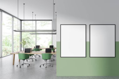 White and green business interior with laptop on desk, armchairs on grey concrete floor. Panoramic window on tropics. Two mock up canvas posters. 3D rendering