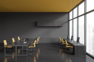 Modern office interior with shared table and laptop. Coworking zone with pc computer, meeting area and panoramic window on skyscrapers. 3D rendering