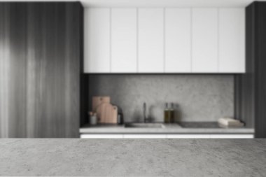 Grey concrete countertop on background of blurred dark kitchen interior. Mockup copy space for product display. 3D rendering