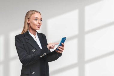 Businesswoman finger touch phone in hand, happy portrait on copy space white background with abstract shadow. Concept of business network and connection