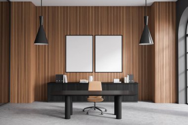 Interior of modern CEO office with grey and dark wooden walls, office table, black file cabinet and two vertical mock up posters hanging above it. Advertising concept. 3d rendering clipart