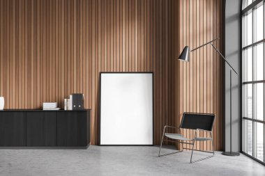 Stylish living room interior with black wooden drawer and armchair, panoramic window on skyscrapers. Chill zone with mock up canvas poster on the floor. 3D rendering