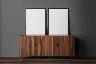 Front view on dark living room interior with two empty white posters, sideboard, grey wall, oak wooden hardwood floor. Concept of minimalist design. Place for meeting. Mock up. 3d rendering