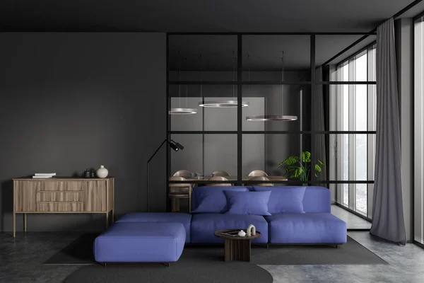 Front view on dark studio room interior with grey wall, couch, armchair, coffee table, concrete floor, glass partition, panoramic window, dining table. Concept of minimalist design. 3d rendering