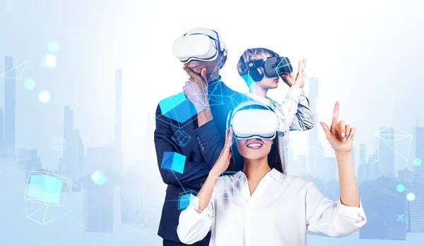 Three business people in vr glasses, working and meeting in digital world, blockchain hologram and overlay with skyscrapers. Concept of teamwork and futuristic lifestyle