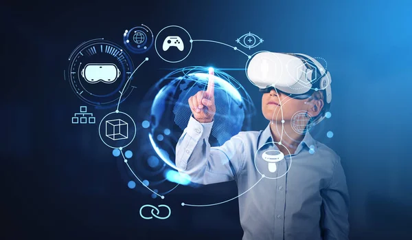 Boy wearing formal wear and vr googles watching at metaverse reality with interface hologram of digital globe, gamepad. Concept of futuristic technology, virtual reality, progressive kids in business