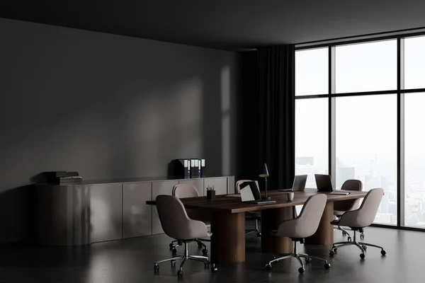 Dark conference interior with armchairs and board, business folders on sideboard. Meeting corner with panoramic window on Paris skyscrapers. Mockup copy space wall. 3D rendering