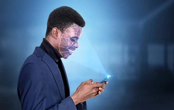 Black businessman profile typing on smartphone in hands, digital biometric scanning. Face detection and recognition. Concept of face id and data access