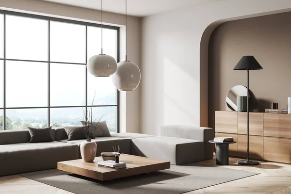 Corner of stylish living room with white and beige walls, wooden floor, gray sofa, square table and panoramic window with blurry mountain scenery. 3d rendering