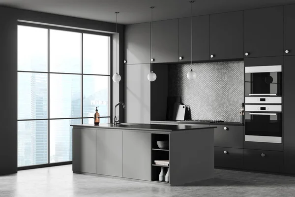 stock image Dark home kitchen interior with bar island, side view cooking corner with kitchenware. Grey eating area with panoramic window on skyscrapers. 3D rendering