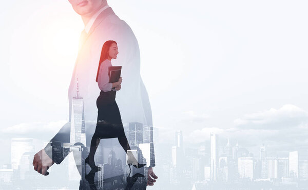 Businessman and businesswoman walking, two people silhouette walking, double exposure, New York skyline. Concept of communication and teamwork