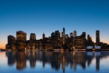 Magnificent night New York city and its reflection in the Hudson river. New York, the United States of America. Concept of sightseeing and tourism clipart