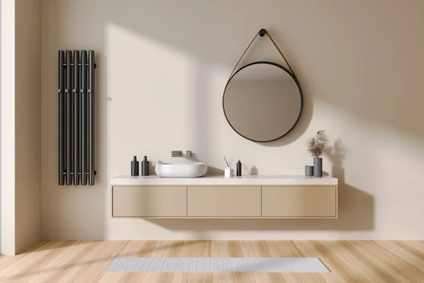 Beige bathroom interior with sink and round mirror, drawer and towel rail on wall. Minimalist bathing accessories and carpet on hardwood floor. 3D rendering
