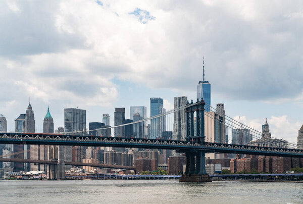 Majestic New York city panorama with Brooklyn bridge on cloudy day. New York, the United States of America. Concept of sightseeing and tourism