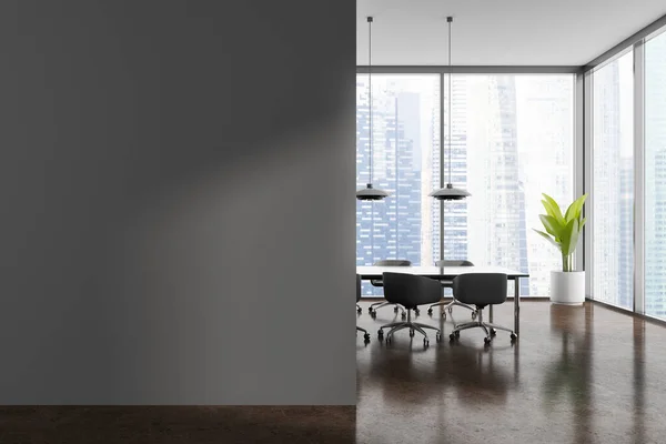Interior of modern conference room with gray walls, brown floor, long table with chairs, panoramic window with blurry cityscape and mock up wall on the left. 3d rendering