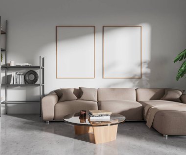 Beyaz duvarları, beton zemini, rahat gri kanepesi ve üzerinde iki tane dikey maket posteriyle şık bir oturma odası. 3d oluşturma