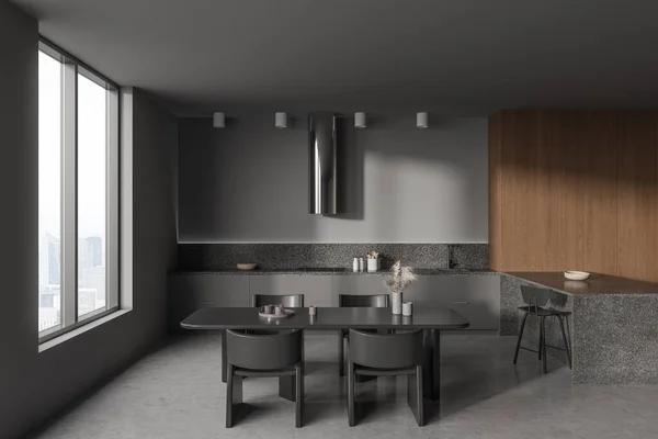 stock image Dark home kitchen interior with cooking and dining area, bar island with chair. Modern eating zone design, grey concrete floor. Panoramic window on skyscrapers. 3D rendering