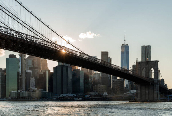 View of Brooklyn bridge and cityscape of New York city skyscrapers on sunny day. New York, the United States of America. Concept of sightseeing and tourism