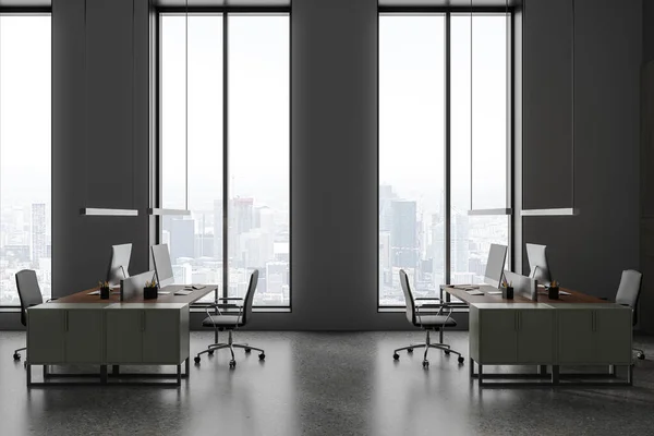 Dark office interior with pc computer on desk with armchairs, grey concrete floor. Coworking zone with panoramic window on Paris skyscrapers. 3D rendering