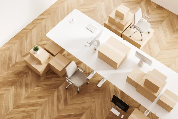 stock image Top view of conference room interior with moving boxes on board, armchair and pc computer, hardwood floor. Concept of relocation. 3D rendering