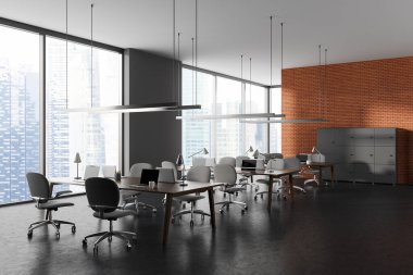 Karanlık, modern, gri koltuklu tuğla ofis içi, yan masası dizüstü bilgisayarı olan gri beton zemin. Birlikte çalışan köşe ve gökdelenlerin panoramik penceresi. 3B görüntüleme