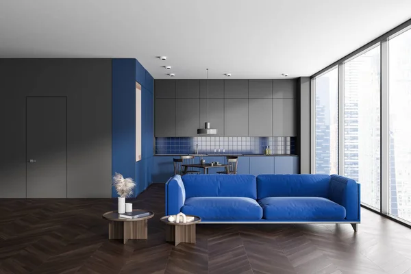 蓝色和灰色的家庭工作室内部与沙发 餐桌与烹饪区与厨房用具 深色硬木地板 摩天大楼上的全景窗户 3D渲染 — 图库照片